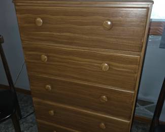 5-drawer wooden chest of drawers featuring a wavy oak-grain finish and round wooden pull knobs, closely resembling models like the Perdue Woodworks Big Chester 5-drawer chest