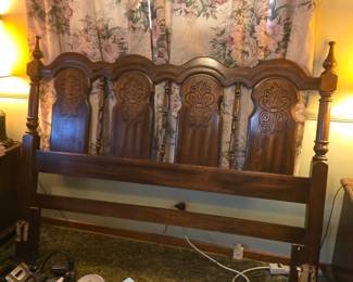 image is a vintage or antique Spanish Colonial Revival / Spanish Mediterranean style carved oak or wood bed headboard (frequently found in full or queen sizes), featuring four arched carved panels and spindle or finial accents.