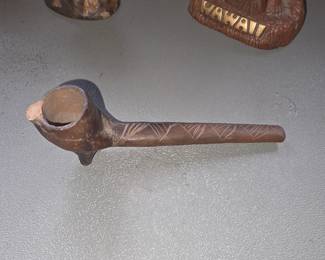 hand-carved wooden tobacco or ceremonial pipe featuring a cylindrical bowl with a small base spur and a