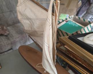 vintage wooden model pond yacht or sloop sailboat featuring a wooden hull, mast, and stitched canvas sails