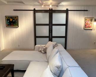 A stylish, inviting sectional that makes a wonderful centerpiece for a living room, family room, or media space. Artwork in the background for sale, many more pieces not shown.