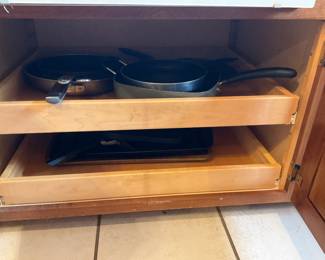Mixed Kitchenware Lot — A large lot of everyday kitchenware including nested stainless mixing bowls, metal cake pans and molds, colanders, a few nonstick frying pans, glass lids, assorted baking tins, plastic storage lids, and small appliances/attachments (hand blender parts and food-processor bowl/blade shown). Pieces are mixed metals, glass and plastic with visible wear and light staining on some cookware; overall serviceable for home use or as backup pieces. No major brand markings visible in photos; items sold as-is and sold together as one lot. Estimated combined size and weight below reflect the full grouped contents.