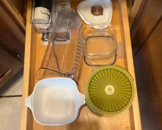 Mixed Kitchenware Lot — A large lot of everyday kitchenware including nested stainless mixing bowls, metal cake pans and molds, colanders, a few nonstick frying pans, glass lids, assorted baking tins, plastic storage lids, and small appliances/attachments (hand blender parts and food-processor bowl/blade shown). Pieces are mixed metals, glass and plastic with visible wear and light staining on some cookware; overall serviceable for home use or as backup pieces. No major brand markings visible in photos; items sold as-is and sold together as one lot. Estimated combined size and weight below reflect the full grouped contents.