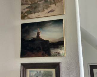 Framed Coastal Landscape Prints Lot — Group of three framed landscape prints showing coastal and pastoral scenes with gilt thin frames and a thicker dark wood frame for the smallest piece. The two small rectangular prints have gold-foil stretcher frames and depict a moody seascape and a cloudy shoreline; the lower piece is matted and housed in a dark wooden frame. Pieces show light surface wear, minor scuffs to frames, and typical age toning to the prints; no visible signatures or maker marks in photos. Overall good decorative condition and ready to hang as a coordinated wall grouping; largest framed print measures approximately 12 x 16 inches.