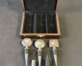 Lot 344h  Set of metal bottle stoppers in wood case