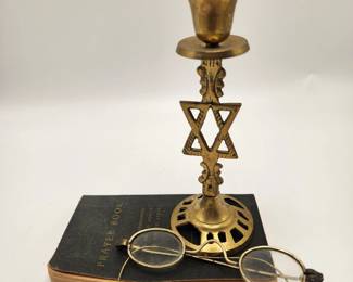 Jewish prayer book, antique spectacles, and a Star of David candle stick