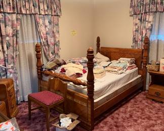 Bed frame with matching vanity and chest of drawers. Linens, sheets, towels, bedspread
