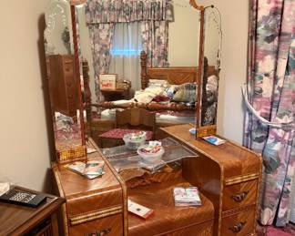 This is a part of a matching set. Bed frame, chest of drawers, Vanity. Estimating it is from the 30s and in excellent condition. The drawer pulls are cool.