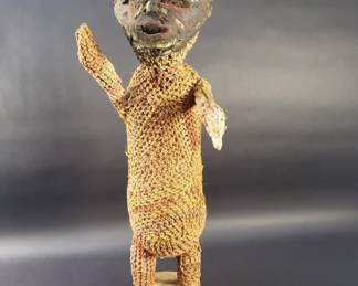 144  Lot 176  African carved wood and woven tribal figurine