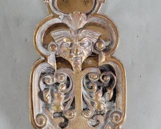 Lot 517  Vintage brass clip depicting a mythological face