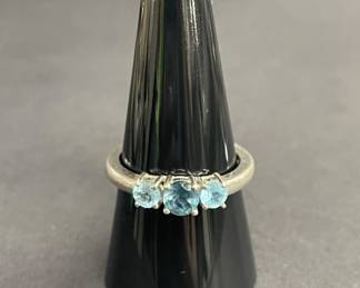 Lot 675h  Sterling silver ring with blue faceted gemstones