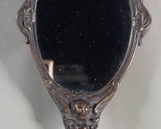 152  Lot 412  Vintage bronze hand held mirror depicting cherubs