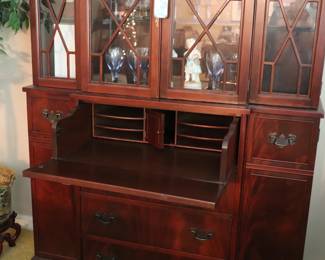 vintage mahogany breakfront china cabinet featuring a drop-front secretary desk