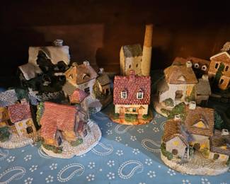 This is a collection of vintage miniature ceramic and resin village cottage figurines.