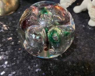 This is a vintage Langham Glass House purple and green bubble paperweight.
