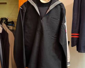 U.S. Navy Enlisted Sailor Black Dress Blue Uniform with White-Trimmed Sailor Collar, Rating Insignia, Matching Trousers and White Dixie Cup Hat