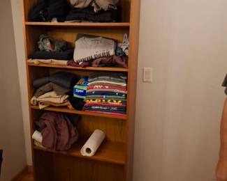 Men’s Casual Clothing Collection Featuring Graphic T-Shirts, Sweatshirts, Jackets, Pants, Shorts & Assorted Everyday Apparel with Woodgrain Five-Shelf Bookcase