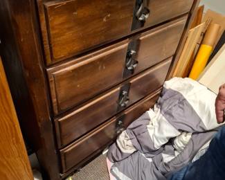 Traditional Dark Wood Four-Drawer Chest of Drawers with Recessed Panel Fronts and Decorative Metal Drop Pulls