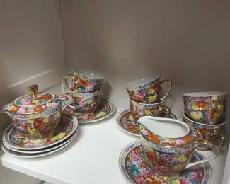 Vintage Chinese Porcelain set featuring a colorful "mille-fleur" or "thousand flowers" pattern with gold gilt accents