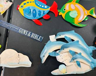 Nothing like cute dolphins and a Gun sign to set the mood.