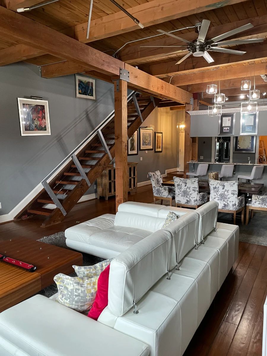Contemporary white leather sectional sofa, two modern contemporary wood coffee tables, floral dining chairs