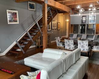 Contemporary white leather sectional sofa, two wood contemporary coffee tables, floral dining chairs, mahogany wood dining table w/ matching bench