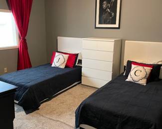 Contemporary faux leather low profile twin beds, white five drawer dresser and black wood chester