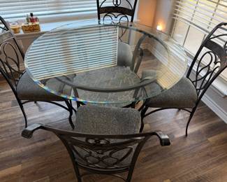 Glass top dining table with wrought iron frame and 4 chairs 