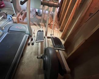 front-drive elliptical trainer with dual-action handlebars and a dark lower flywheel assembly