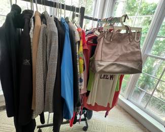 variety of hanging garments and a handbag