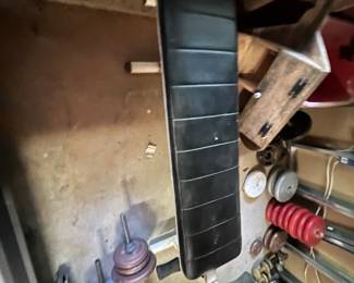 black padded weight lifting or sit-up bench, possibly an older utility or adjustable exercise bench