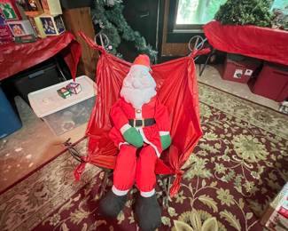 vintage plush Santa Claus figure sitting inside a red nylon parachute-style hanging or swinging chair decoration