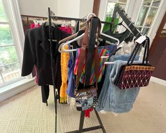 black pinstripe blazer, casual blue denim jeans, and various colorful hanging accessories.