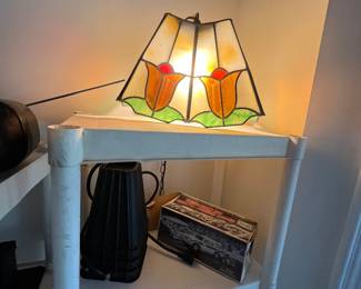 vintage Tiffany-style stained glass lamp featuring a floral tulip motif with orange and yellow petals and green leaves