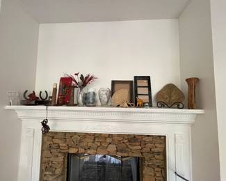 various decorative objects, including framed pictures, vases, small figurines, and floral arrangements.
