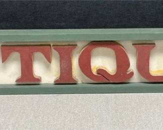 "Antiques" wall sign