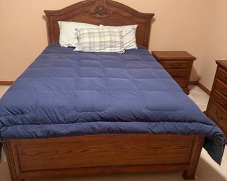 Traditional Oak Queen Bedroom Suite — $750 Includes queen bed, dresser with large mirror, tall chest, and 1 matching nightstand. Excellent condition with beautiful carved detailing and decorative hardware.