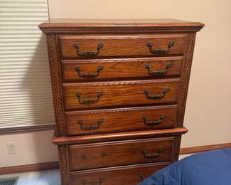 Traditional Oak Queen Bedroom Suite — $750 Includes queen bed, dresser with large mirror, tall chest, and 1 matching nightstand. Excellent condition with beautiful carved detailing and decorative hardware.