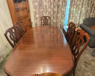 Dining room table with six chairs and corner cabinet
