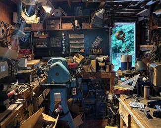 Garage, full of tools, metal drawers and storage containers, and vintage tool parts in boxes