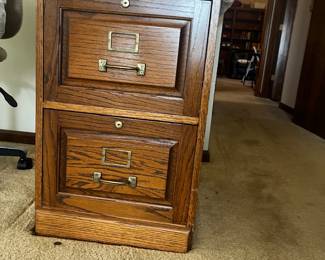 Oak file cabinet with two drawers.