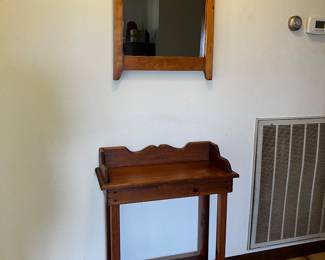 Handsome small wood entry table and wood framed mirror.