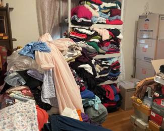 there's a chair under that pink robe to the left. House dresses in every color and pattern you can imagine. it was cute how I thought the sweaters would fit on the shelf.