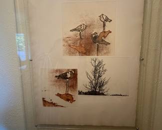 framed mixed-media or print artwork featuring shorebirds and a sparse tree in a minimalist style, possibly an etching or watercolor.