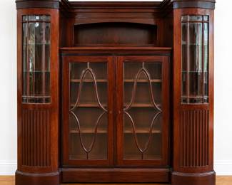 breakfront display cabinet with arched side towers and glass-paneled double doors featuring diamond-shaped wood trim.