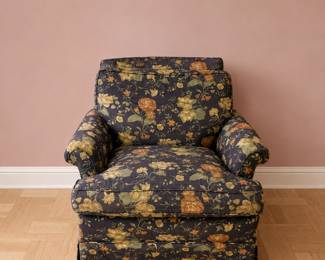 cozy, overstuffed club chair upholstered in a dark floral chintz fabric