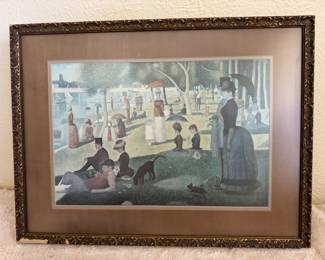 This is a framed print of Georges Seurat's famous pointillist painting, A Sunday Afternoon on the Island of La Grande Jatte, set