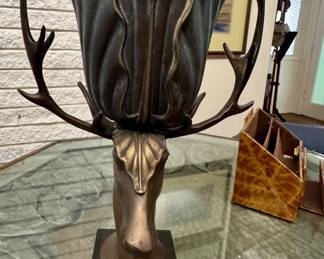Rare bronze figural stag urn and planter sculpture. Perfect patina curved antlers acting as handles, supporting a flared, petal-like vessel