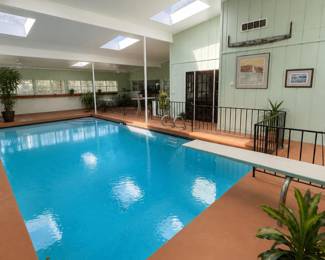 Indoor pool area has lots of house plants for sale