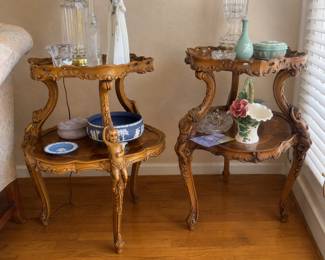 pair of vintage two-tier wooden accent tables featuring intricate marquetry inlay and carved cherub accents in the French style